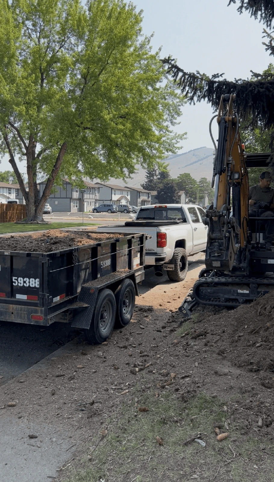 Truck, loaded dump trailer and mini excavator