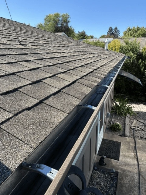 Clean gutter along a roof